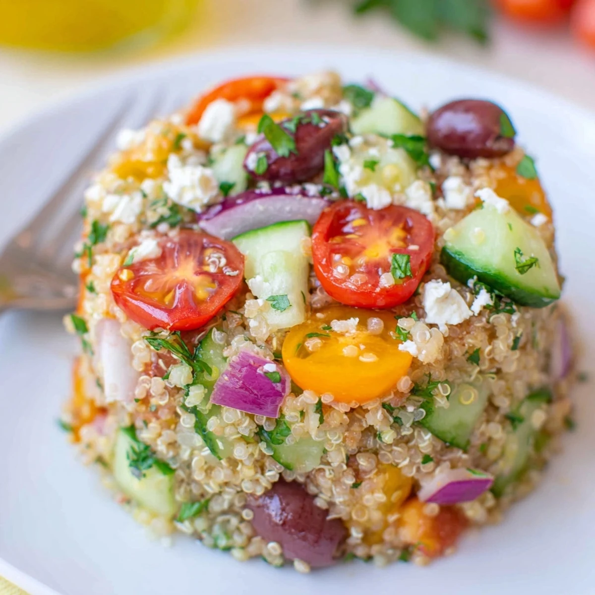 Bright bowl of Greek Quinoa Salad Recipe with juicy tomatoes and feta