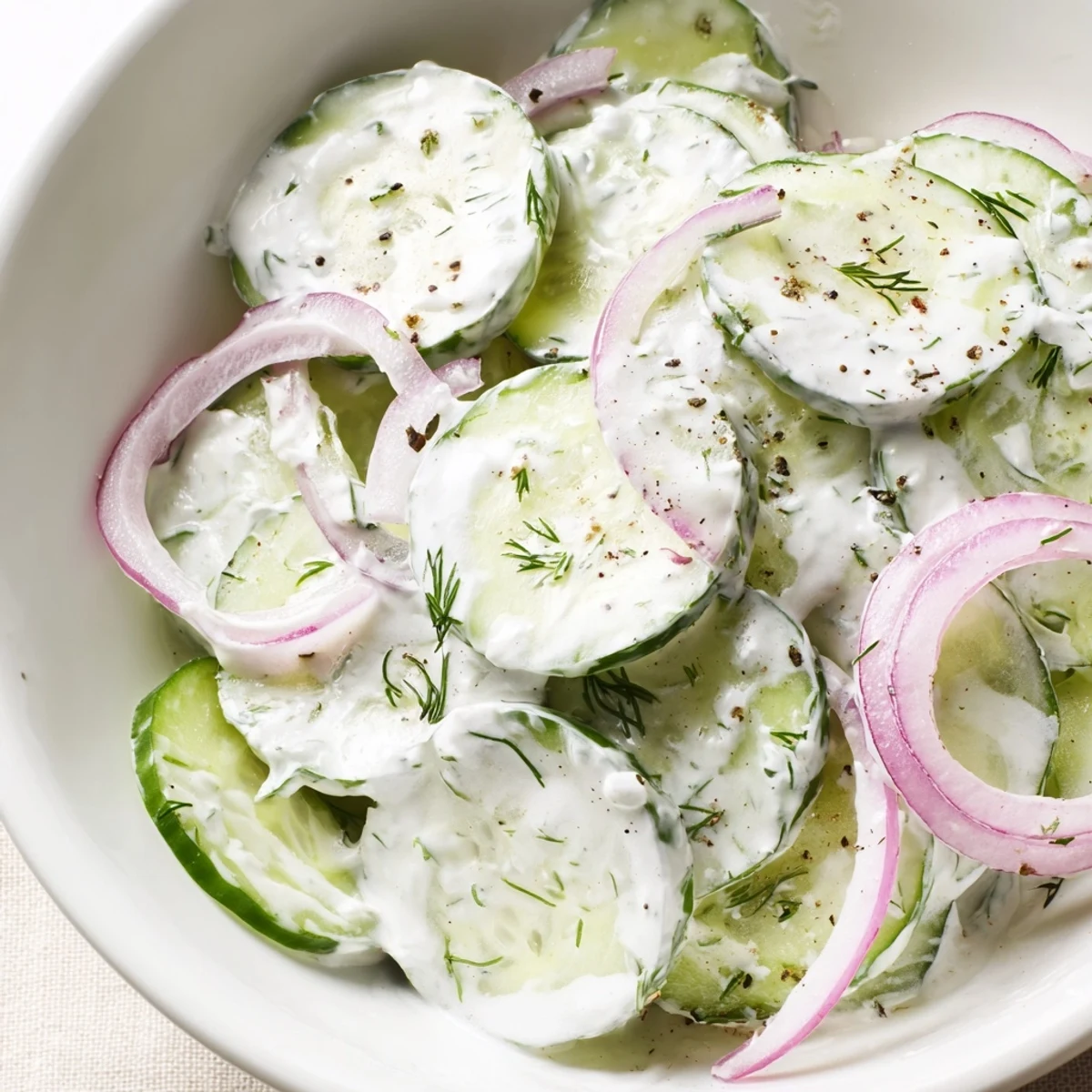 Bright Greek Yogurt Cucumber Salad with tangy lemon-garlic dressing and herb flecks