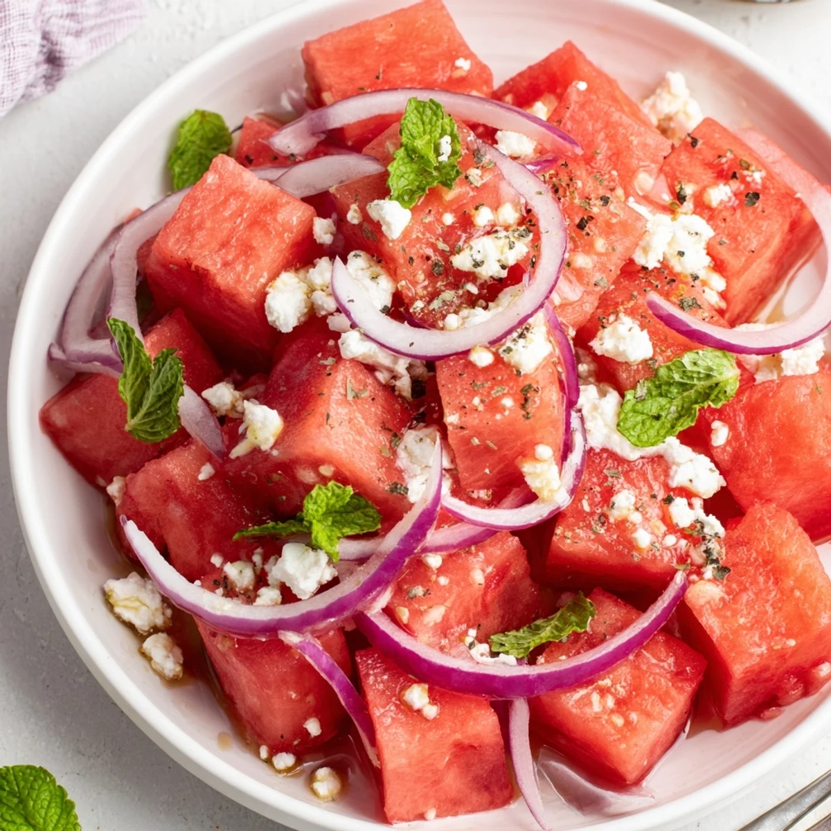 Simple Watermelon Salad With Feta And Mint, tossed with lime and olive oil  