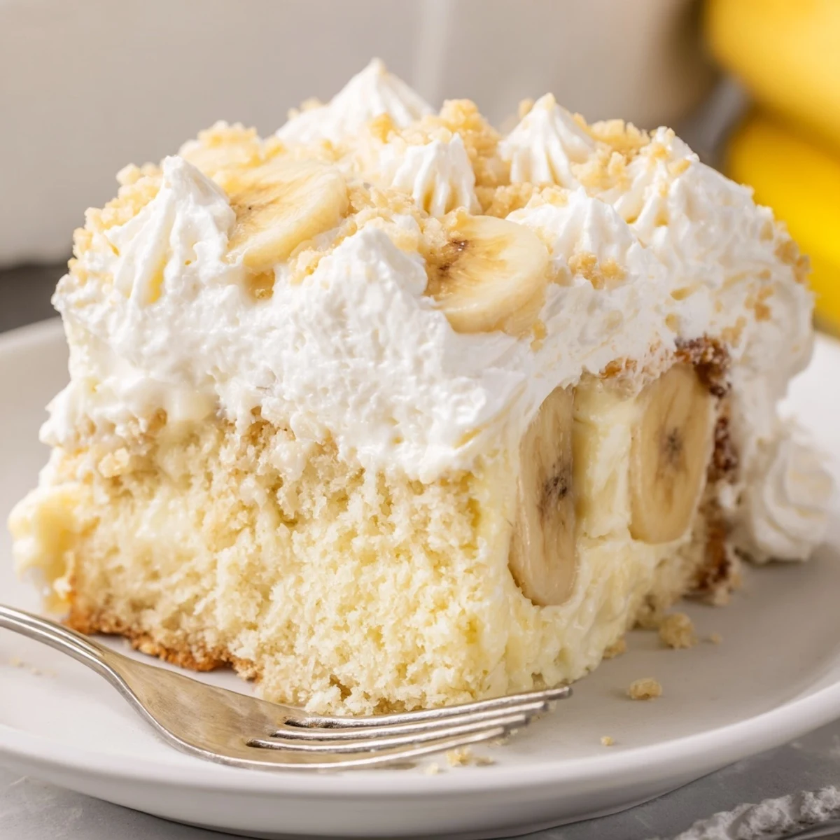 Homestyle Banana Pudding Cake Recipe chilled, topped with whipped cream and crushed wafers.