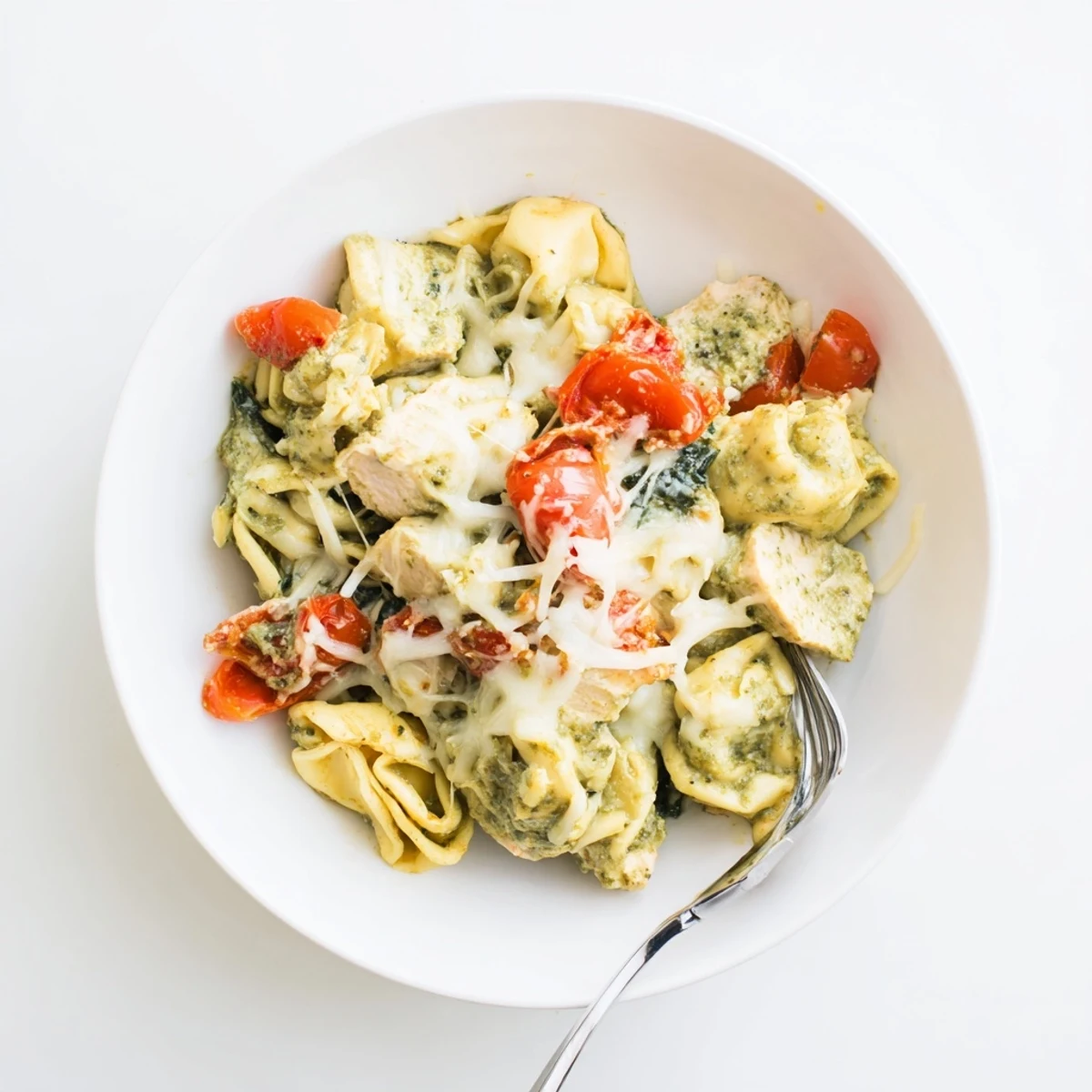 Slow Cooker Tortellini Casserole With Cheesy Chicken Pesto bubbling, creamy, served with fresh basil