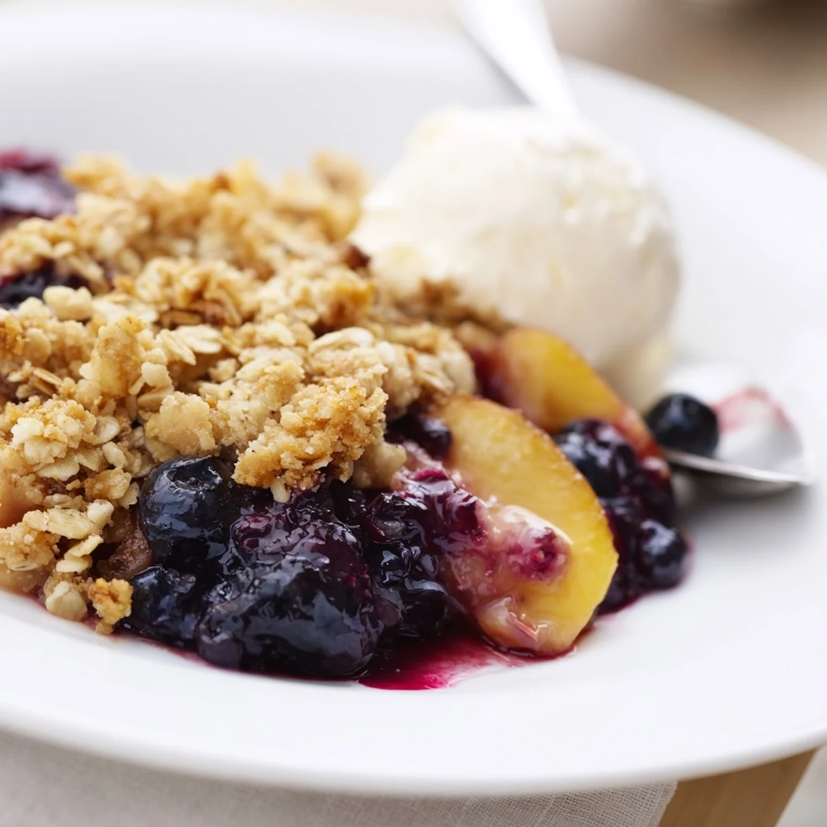 Rustic Blueberry Peach Crumble cooling slightly, buttery oat crumble crackling underneath