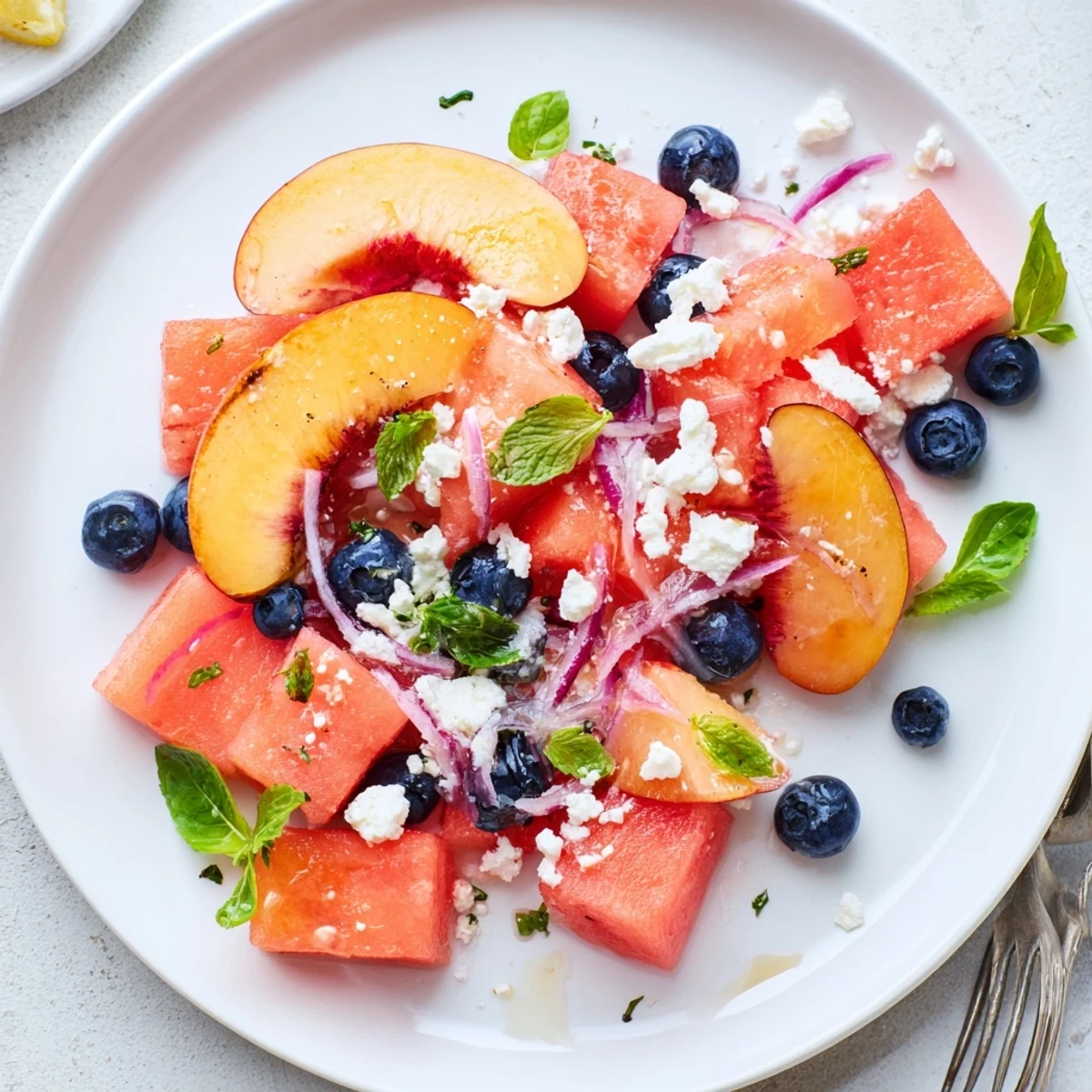 Vibrant Peach Watermelon Salad With Feta showing sweet fruit, tangy cheese, herbs