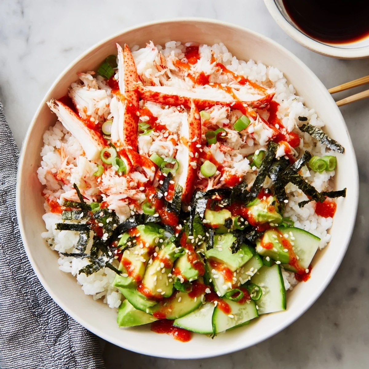 Homemade California Roll sushi bowl arranged with sesame-crusted toppings and nori strips