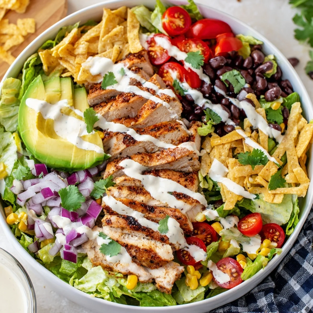 Fresh Southwestern chicken salad featuring seasoned grilled chicken over crisp romaine, avocado, corn, and zesty yogurt dressing.