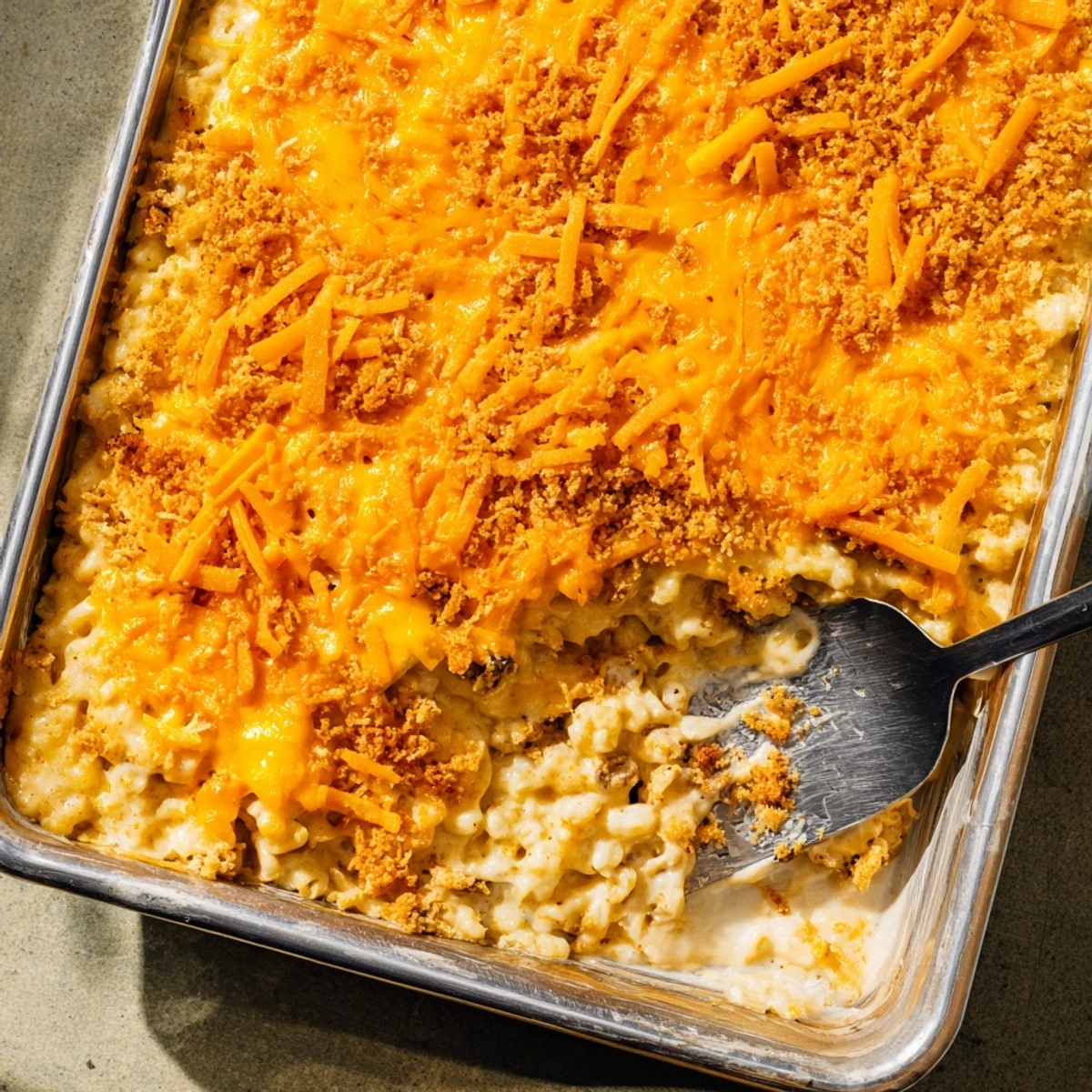 Hearty meatloaf base layered with creamy cheddar macaroni in this comforting American casserole dish