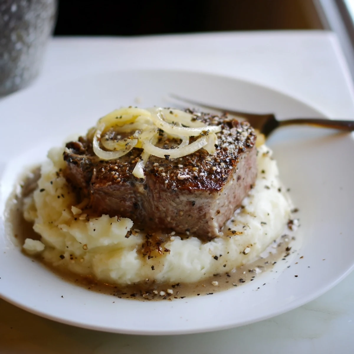 Country Style Smothered Cube Steak Recipe showing browned edges and tender, saucy slices