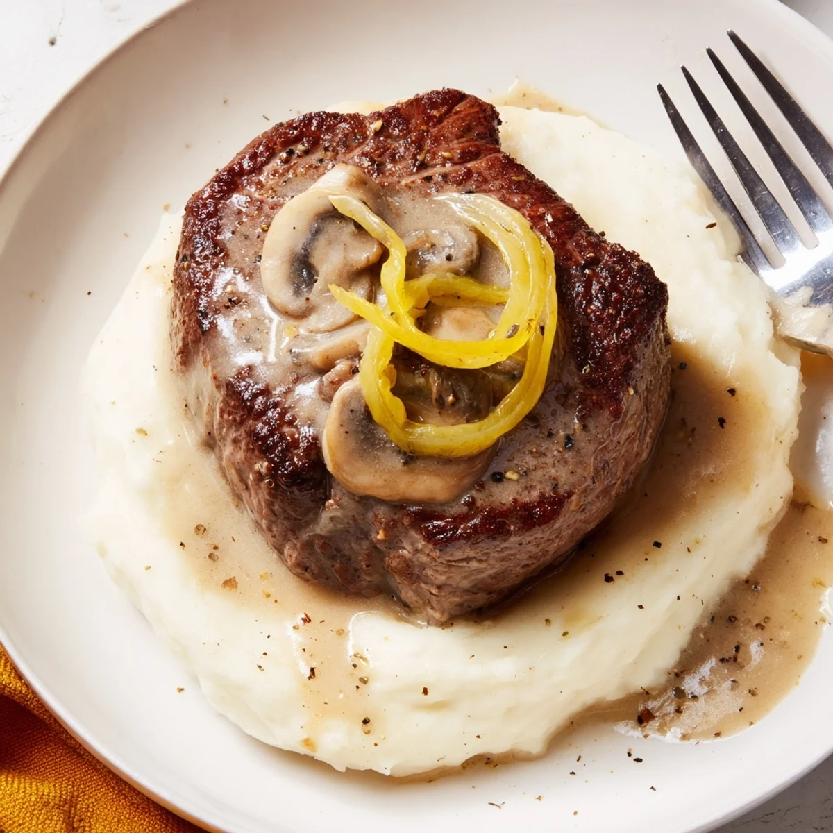 Country Style Smothered Cube Steak Recipe simmered in skillet, served over creamy rice