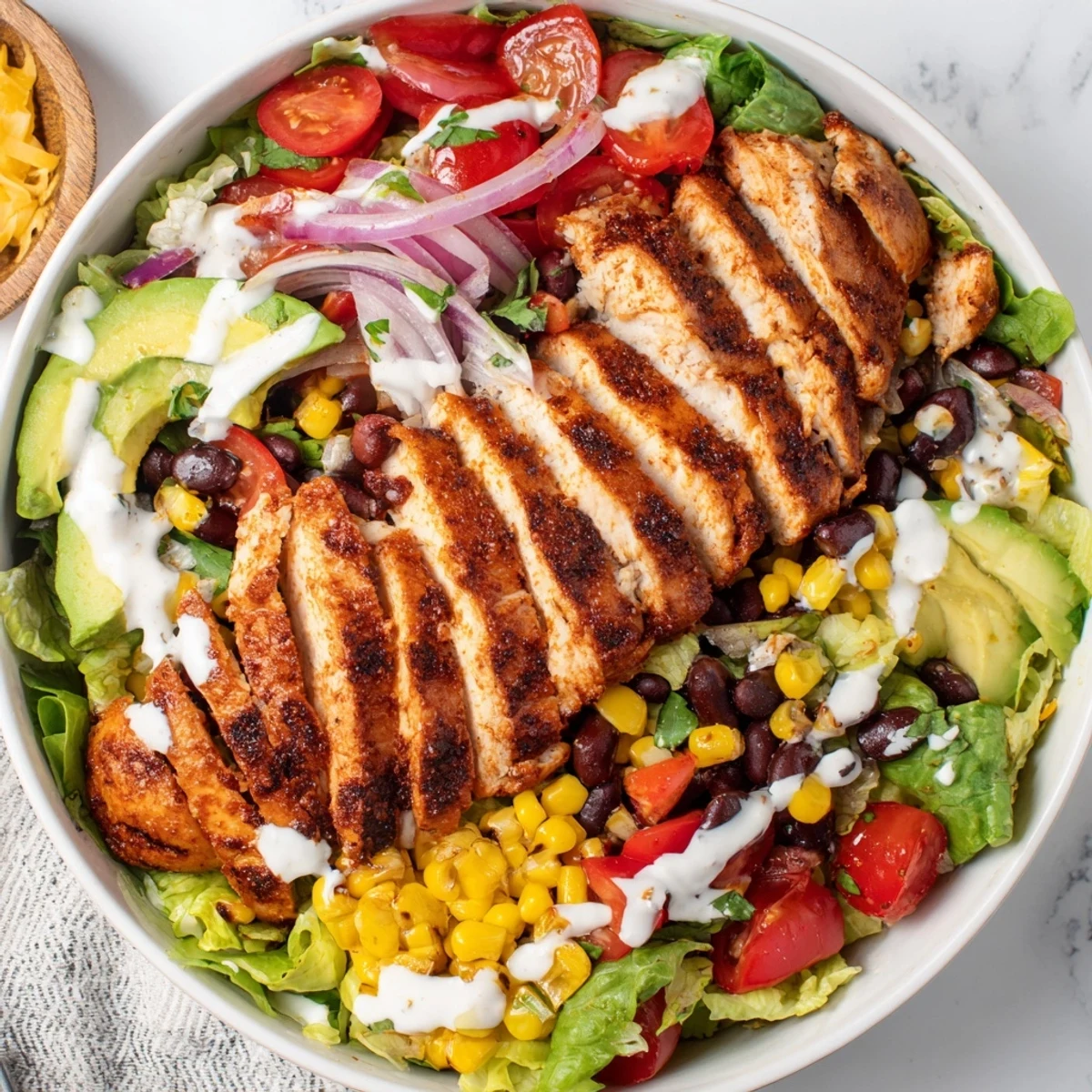 Southwestern Chicken Salad featuring roasted corn, black beans, creamy avocado slices