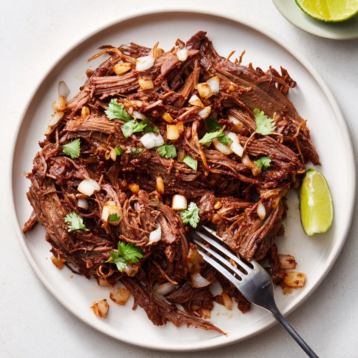Slow Cooker Beef Barbacoa piled on warm tortillas, steaming, tender, smoky