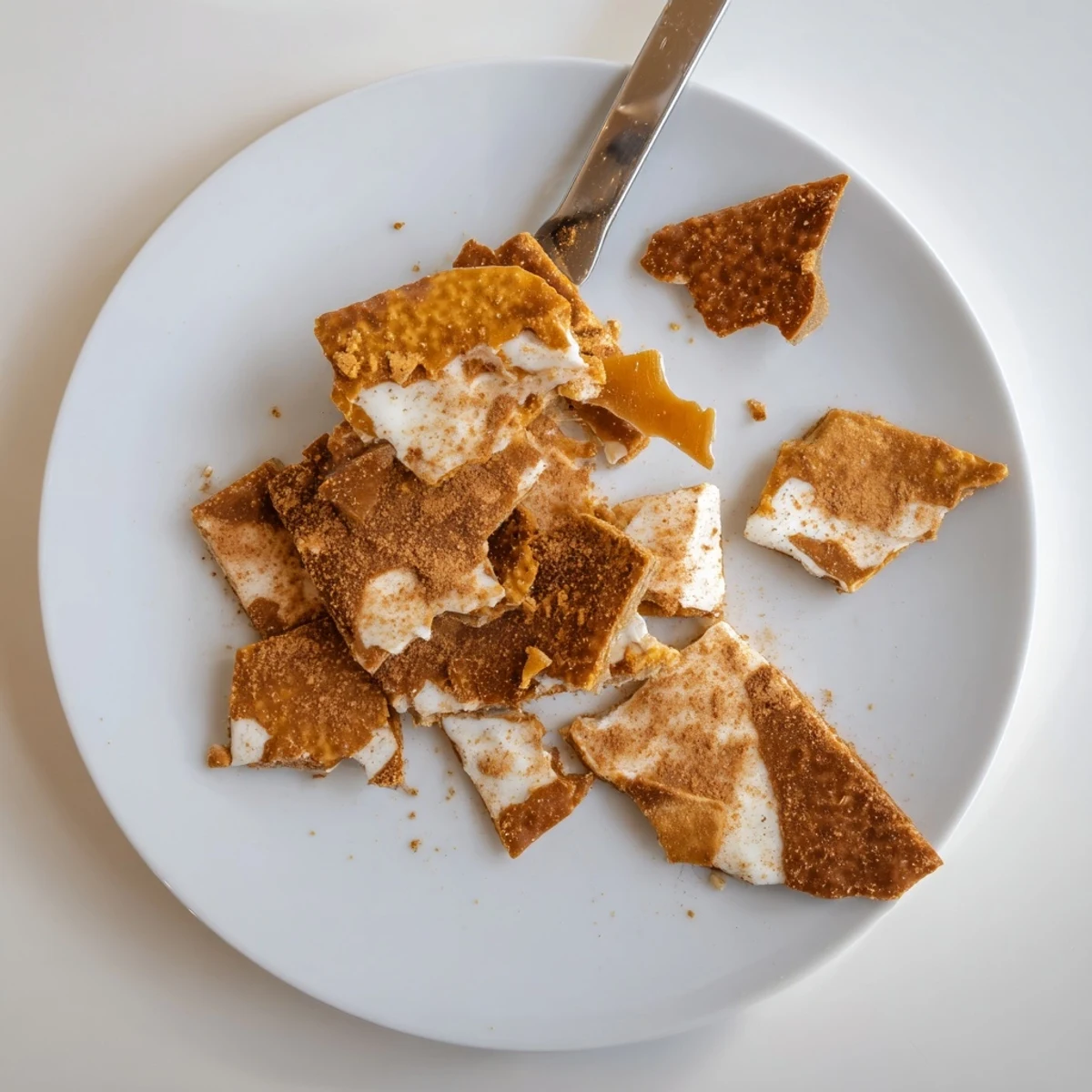Crackled Churro Saltine White Toffee squares drizzled with caramel on a parchment-lined tray