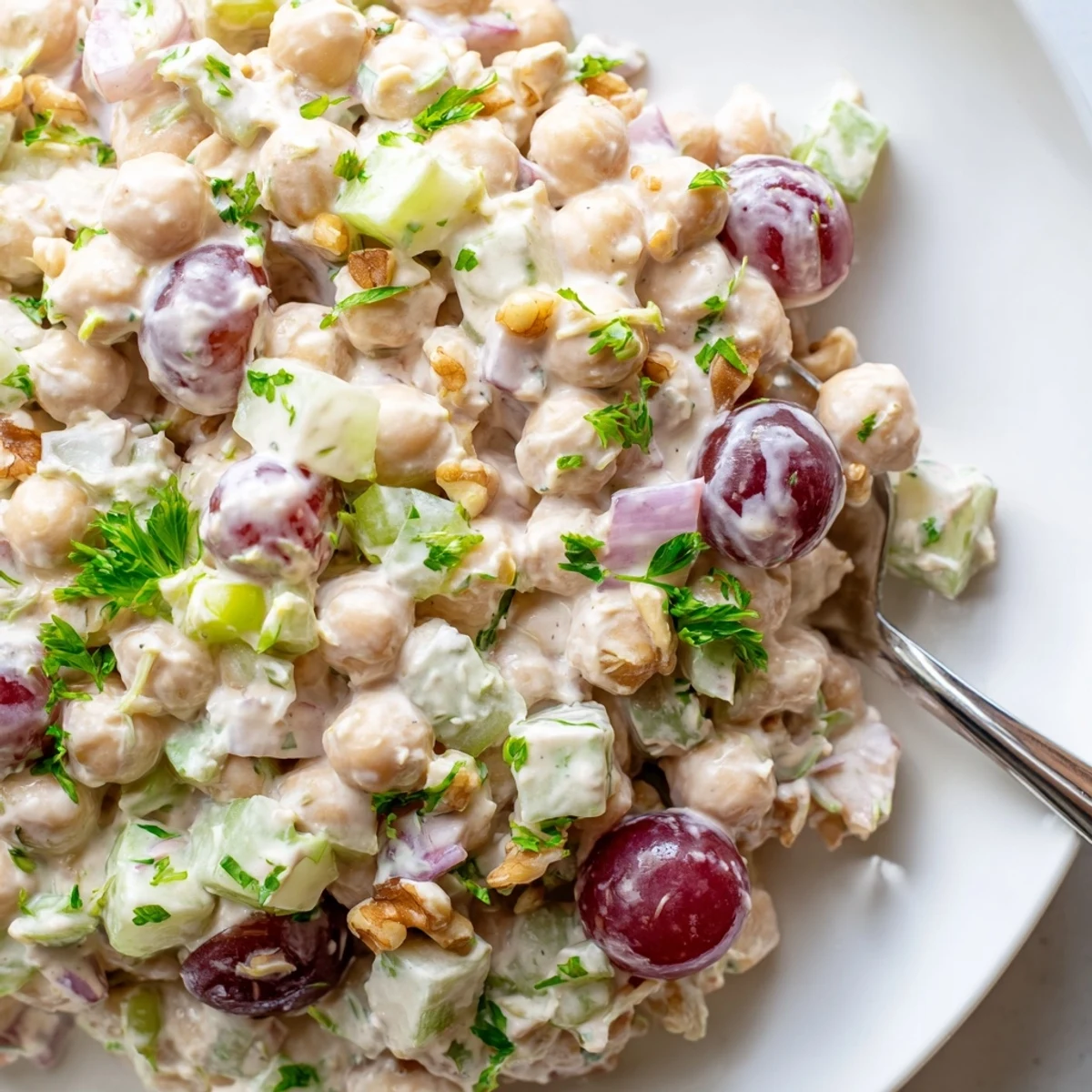 Vibrant vegan chicken salad scooped over crisp lettuce with grapes and celery