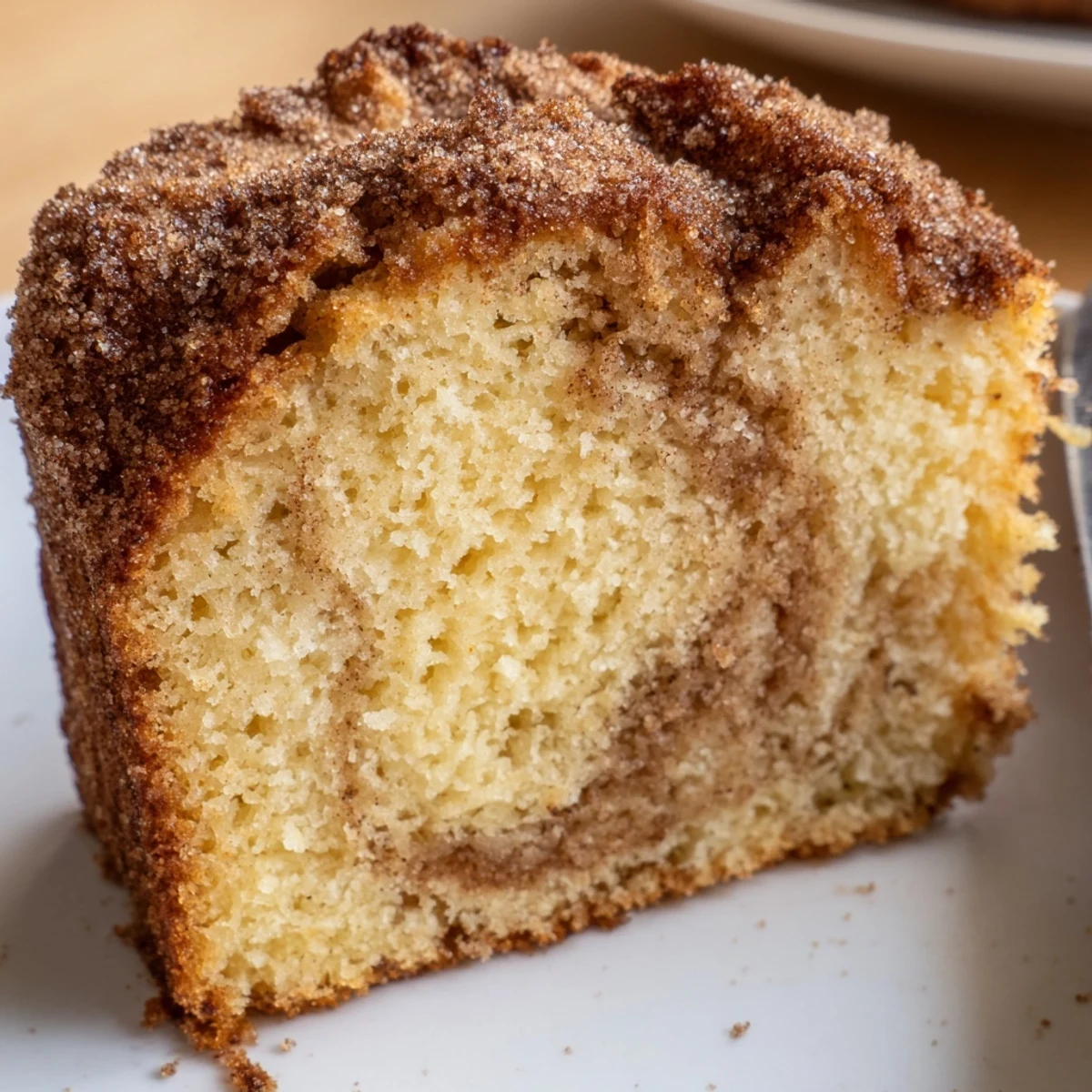 Warm cinnamon donut loaf sliced thick with a golden crust and tender buttery crumb