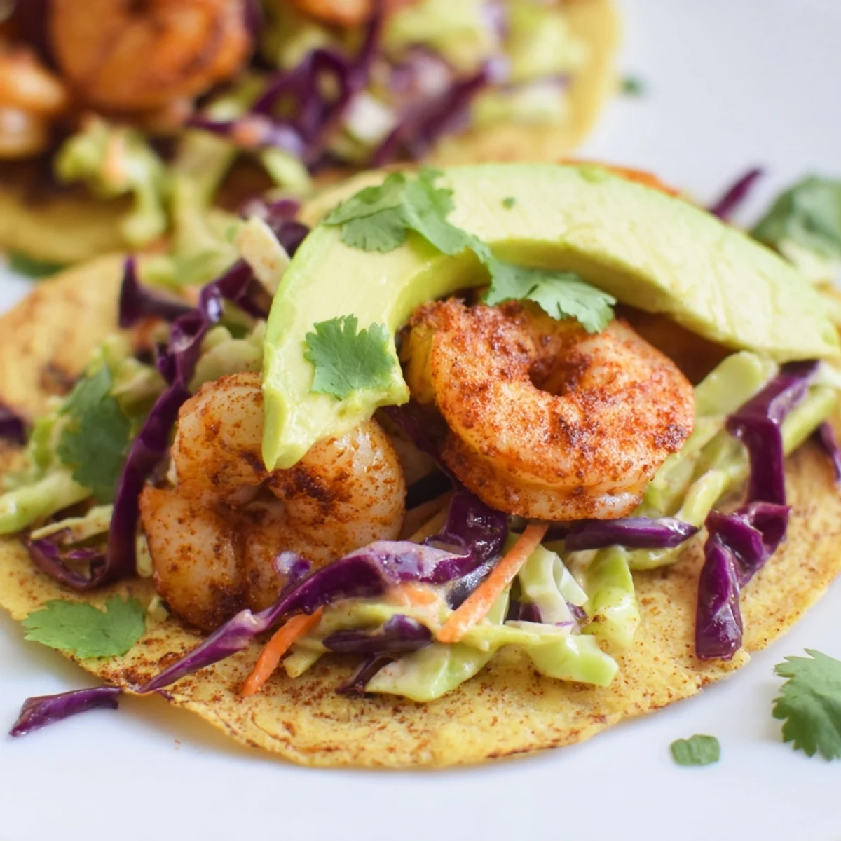 Golden spicy shrimp tacos with garlic cilantro lime slaw on warm tortillas