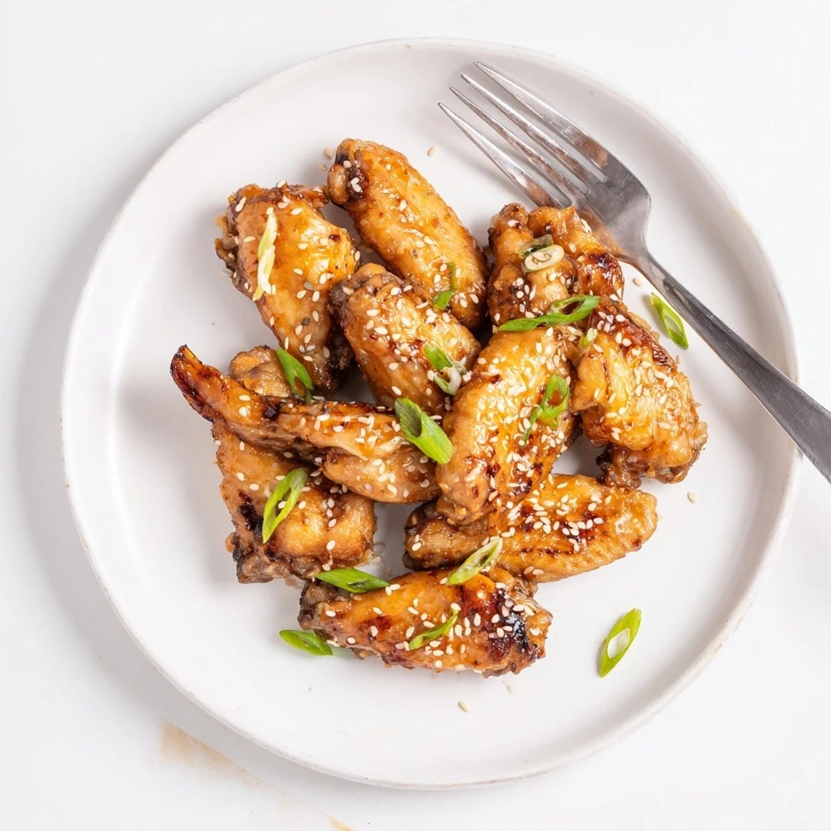Crispy miso honey marinated chicken wings glazed golden on a rustic baking sheet