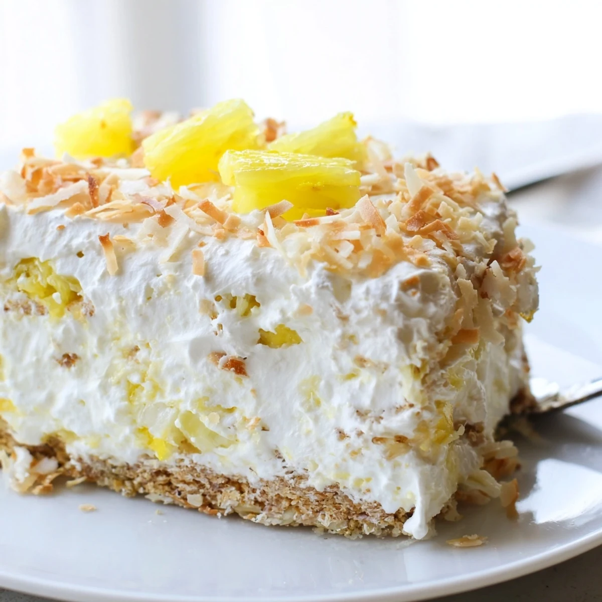 No Bake Pineapple Coconut Cream Cake with a buttery graham cracker crust and whipped topping