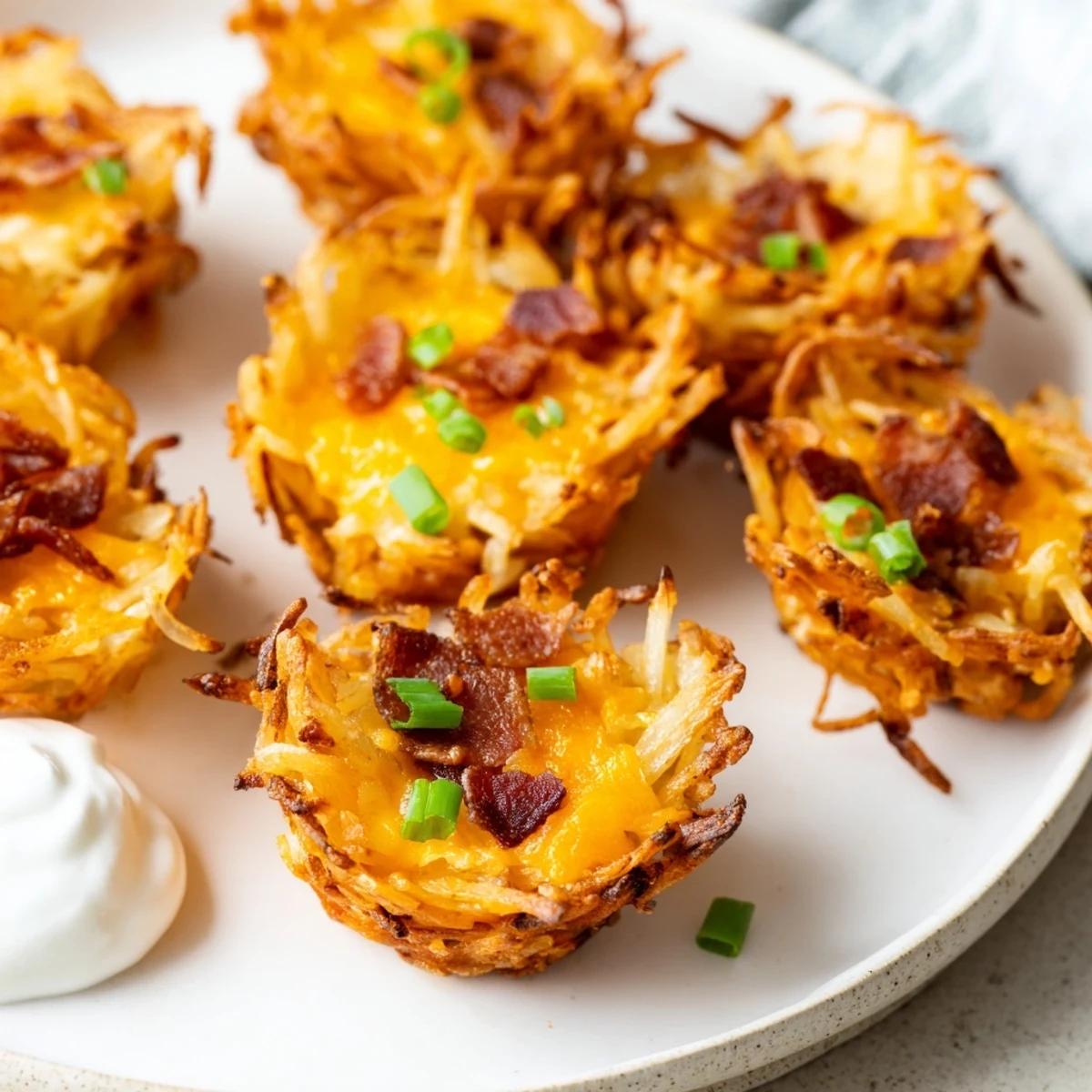 Crispy hashbrown bites loaded with gooey cheese smoky bacon and fresh green onions