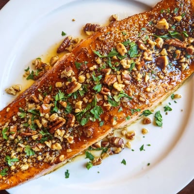Baked Salmon with Maple Glaze and Toasted Pecans fresh from the oven, flaky and moist with a caramelized topping, ready to serve for dinner.