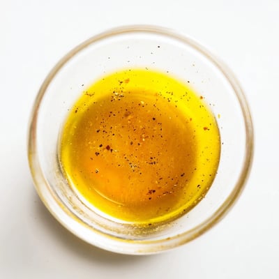 Smooth honey vinaigrette dressing whisked in a glass jar for salads.